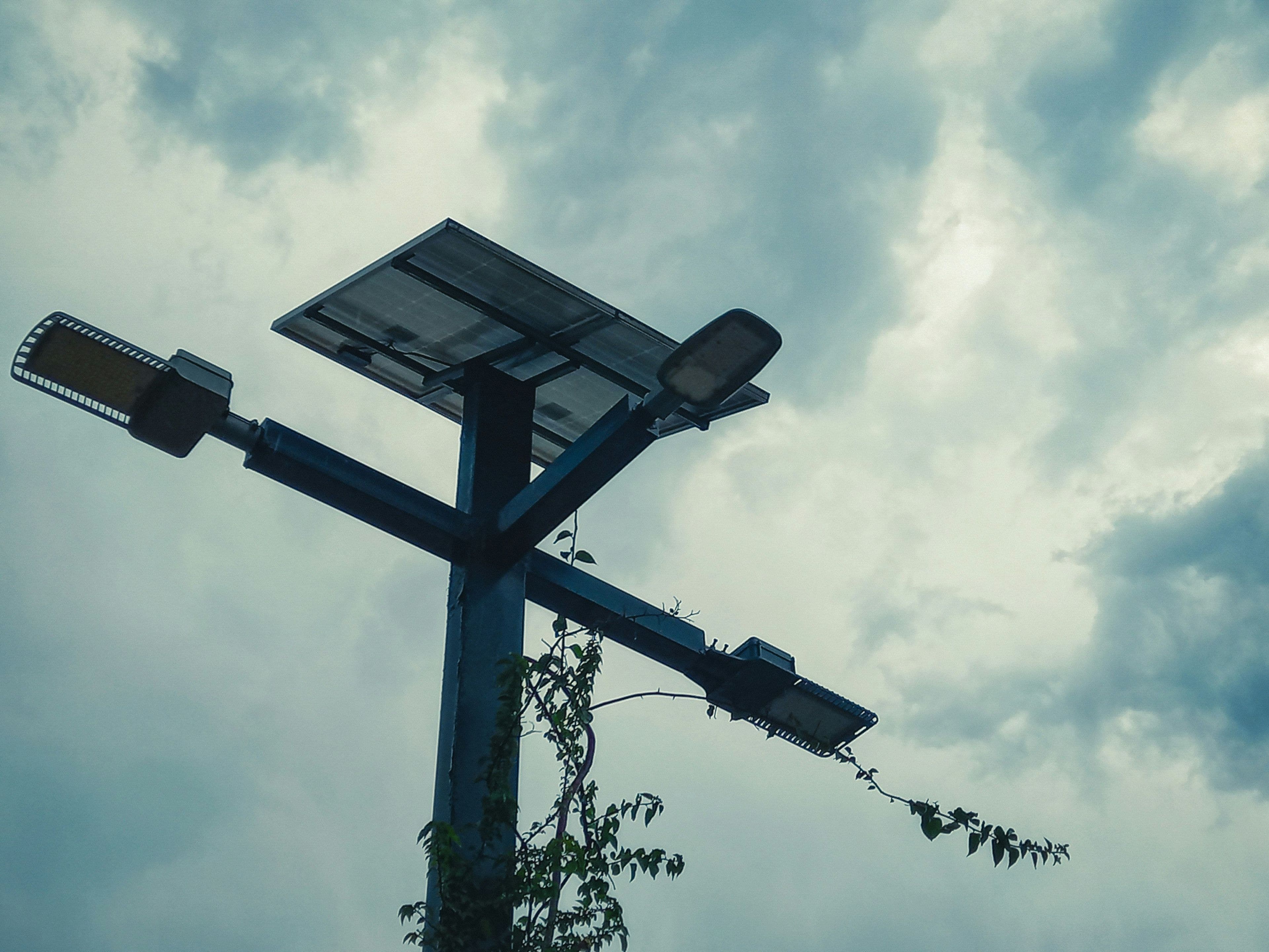 A portable solar power bank with a foldable panel charging outdoors in the sun